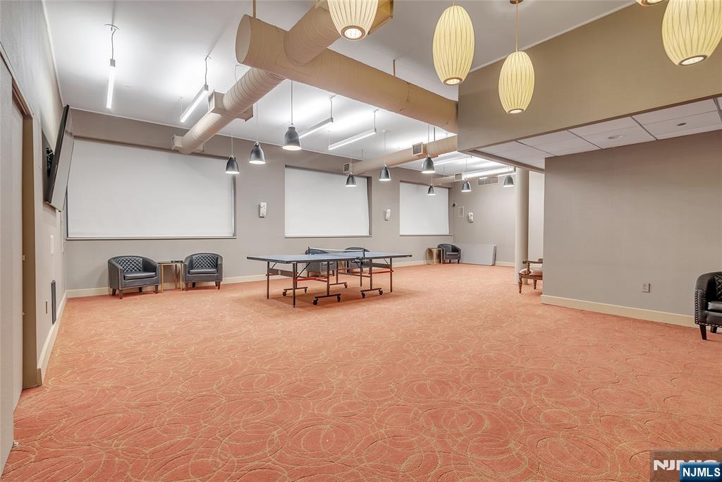 250 Gorge Road, Unit 21E Cliffside Park, NJ 07010 - Photo 13 of 21 a large room with lots of furniture and chandelier