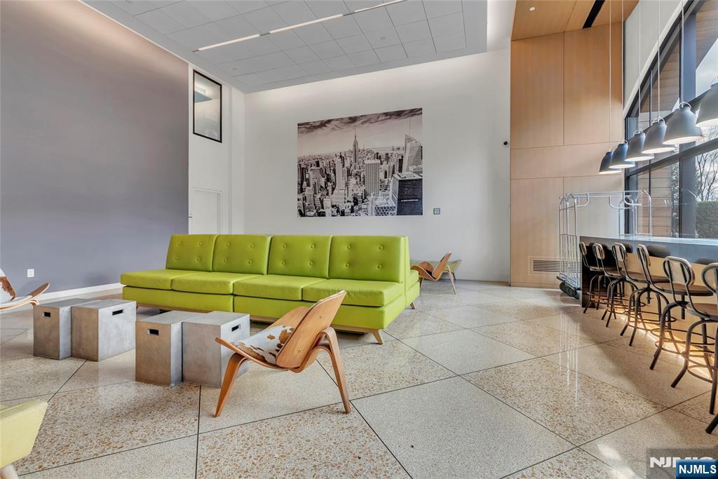 250 Gorge Road, Unit 21E Cliffside Park, NJ 07010 - Photo 16 of 21 a living room with furniture and a dining table with chair