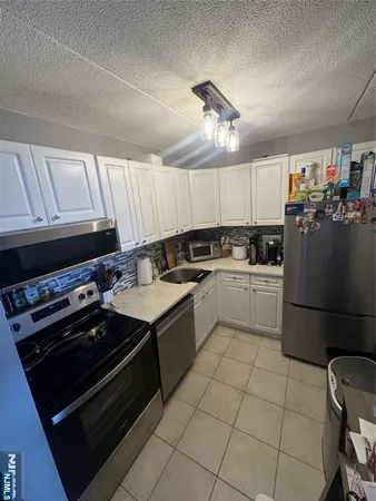 a kitchen with a stove a sink and a refrigerator