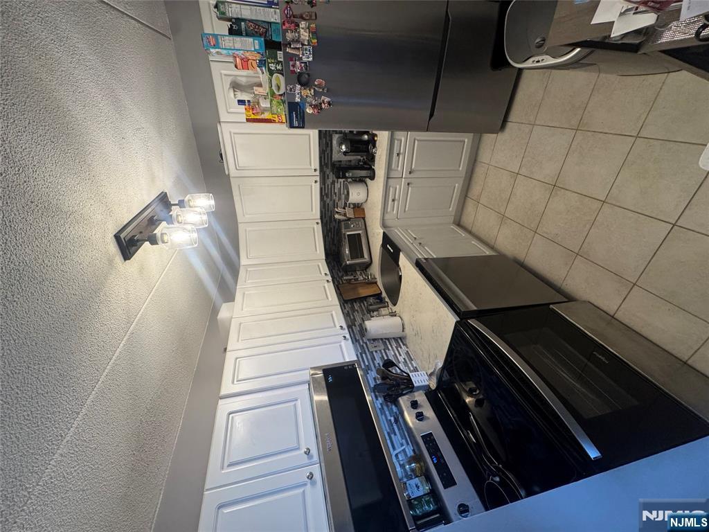 250 Gorge Road, Unit 21E Cliffside Park, NJ 07010 - Photo 3 of 21 a kitchen with a stove a sink and a refrigerator