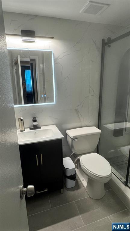 250 Gorge Road, Unit 21E Cliffside Park, NJ 07010 - Photo 8 of 21 a bathroom with a sink mirror vanity and toilet