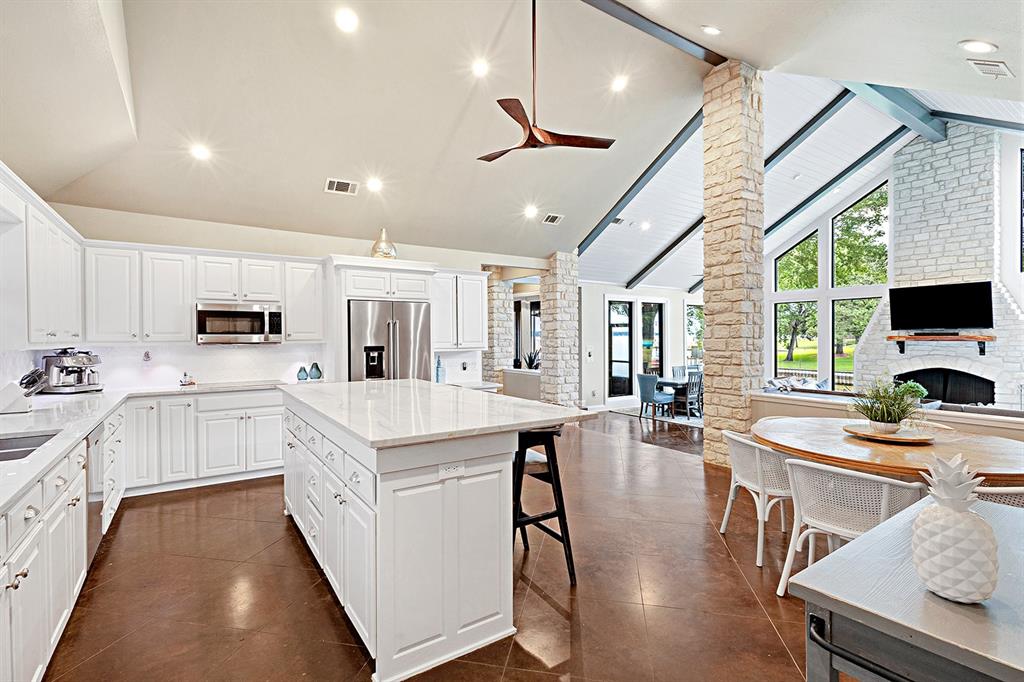103 Glenn Road Mabank, TX 75156 - Photo 12 of 38 a kitchen with white cabinets and stainless steel appliances