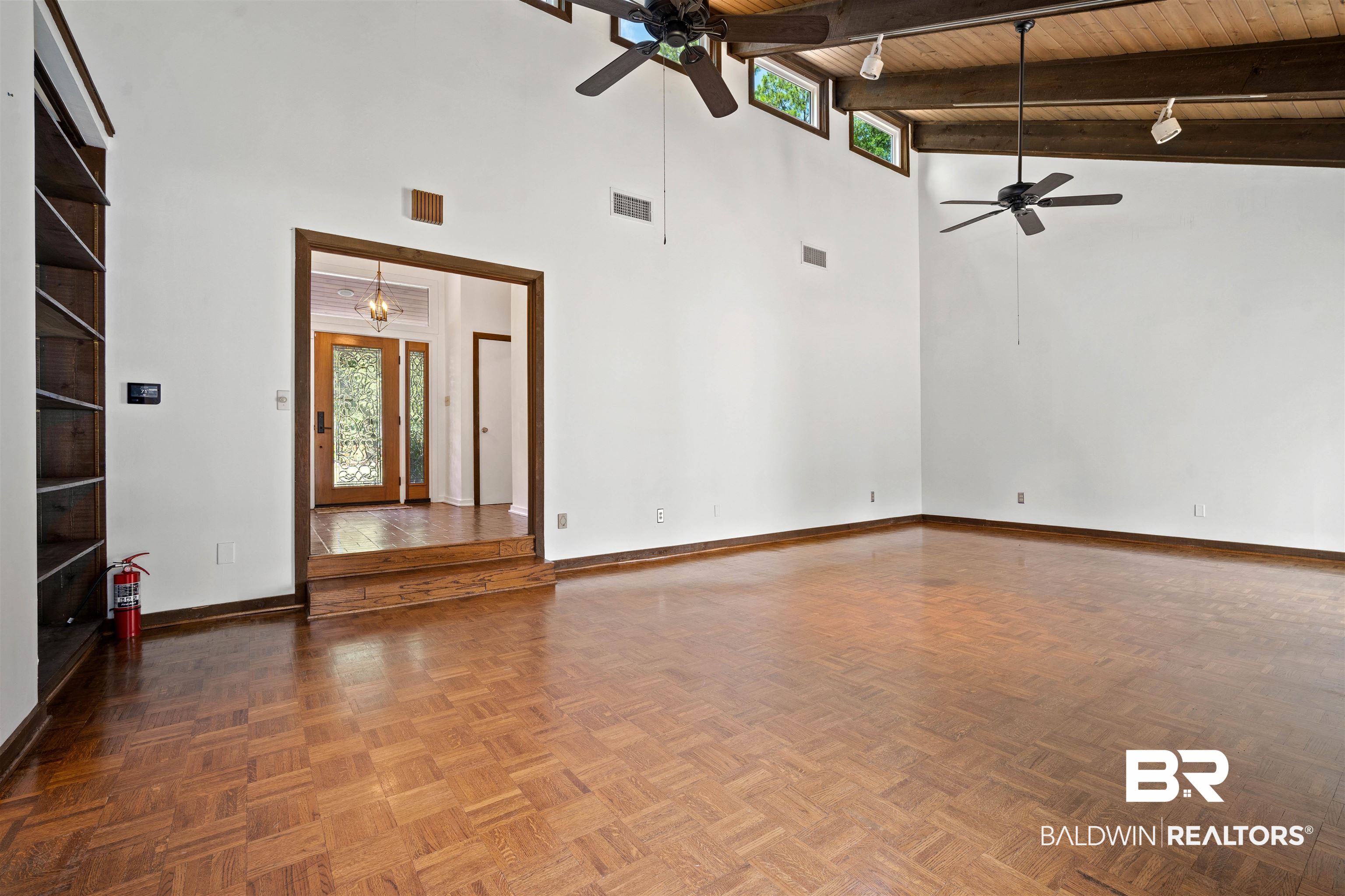 7912 Yorkhaven Road Mobile, AL 36695 - Photo 6 of 41 Unfurnished living room featuring a wooden ceiling with exposed beams, a towering ceiling, and a ceiling fan