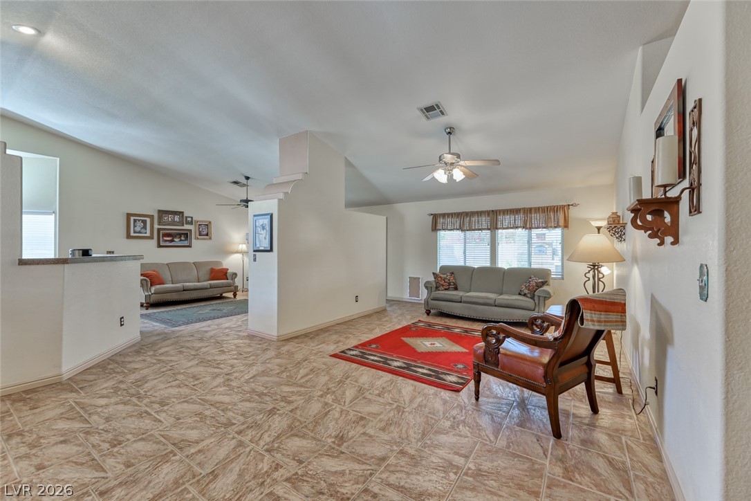 2001 Appaloosa Road Henderson, NV 89002 - Photo 16 of 44 This bright living area features vaulted ceilings and tiled floors, creating an inviting space.