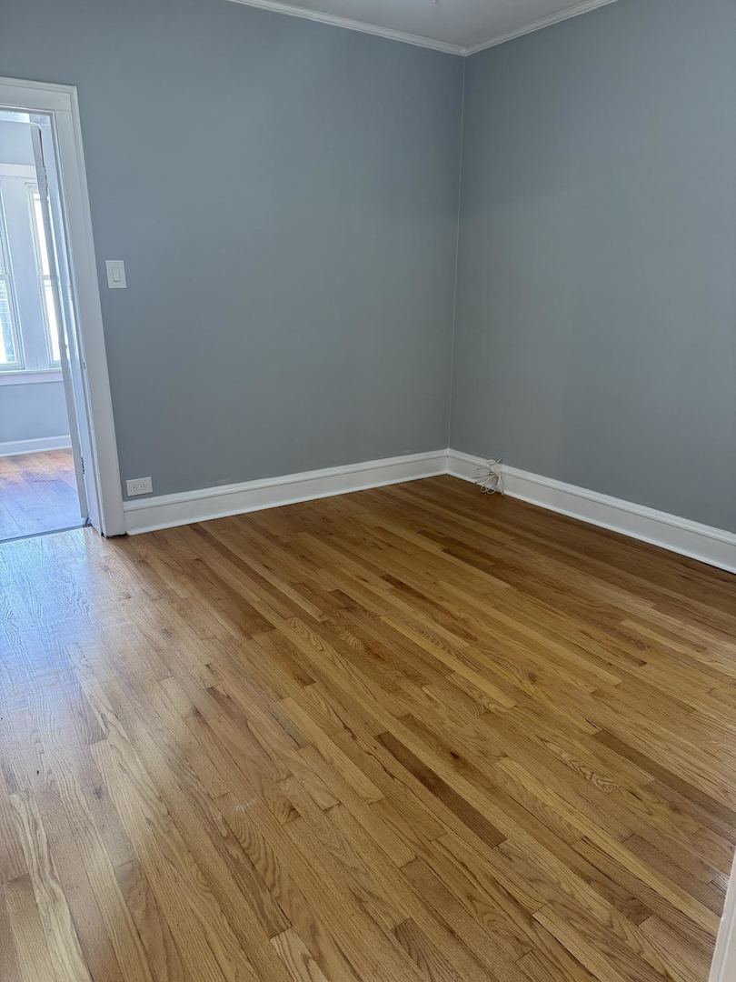 6231 North Francisco Avenue, Unit 2S Chicago, IL 60659 - Photo 11 of 24 a view of empty room with wooden floor