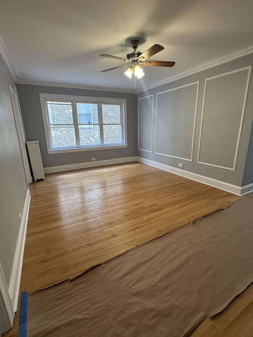 6231 North Francisco Avenue, Unit 2S Chicago, IL 60659 - Photo 12 of 24 a view of an empty room with wooden floor and a window