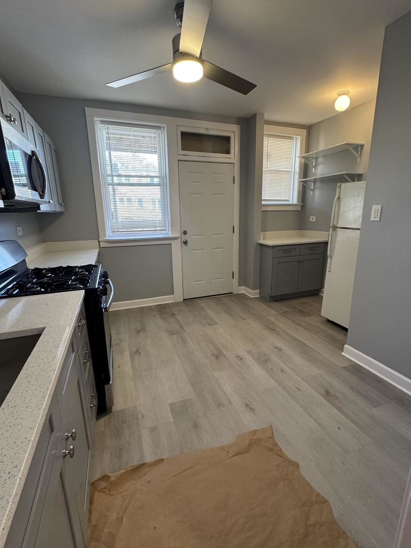 6231 North Francisco Avenue, Unit 2S Chicago, IL 60659 - Photo 19 of 24 a view of kitchen with window and wooden floor