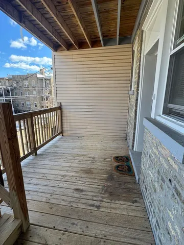 a view of a balcony with wooden floor