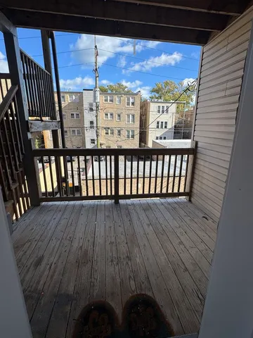 a view of a balcony with wooden floor