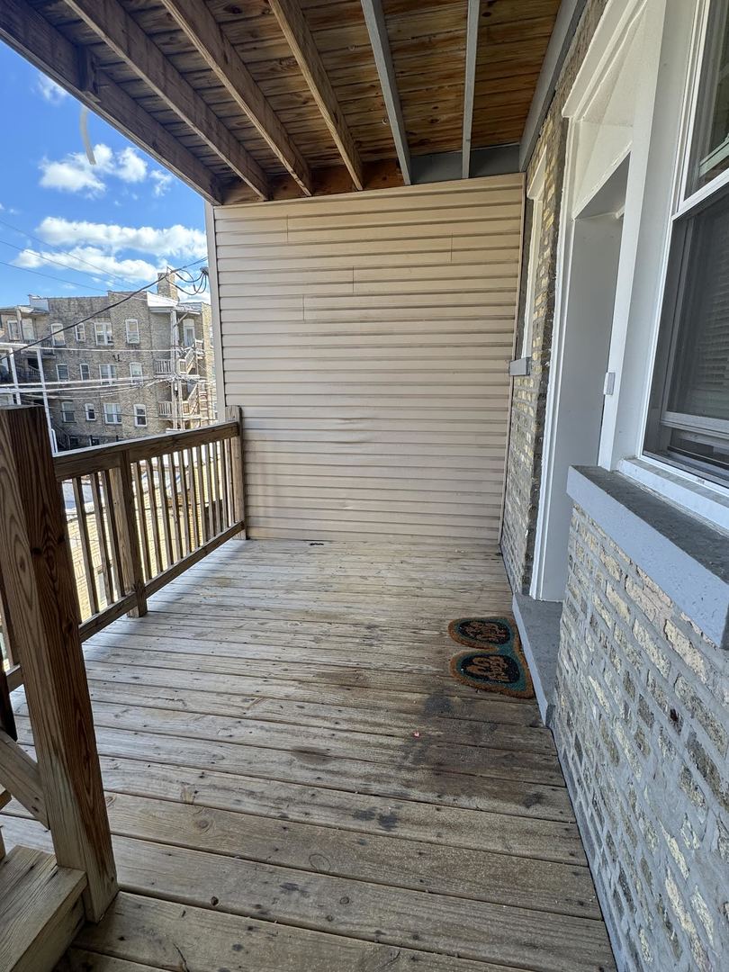 6231 North Francisco Avenue, Unit 2S Chicago, IL 60659 - Photo 23 of 24 a view of a balcony with wooden floor