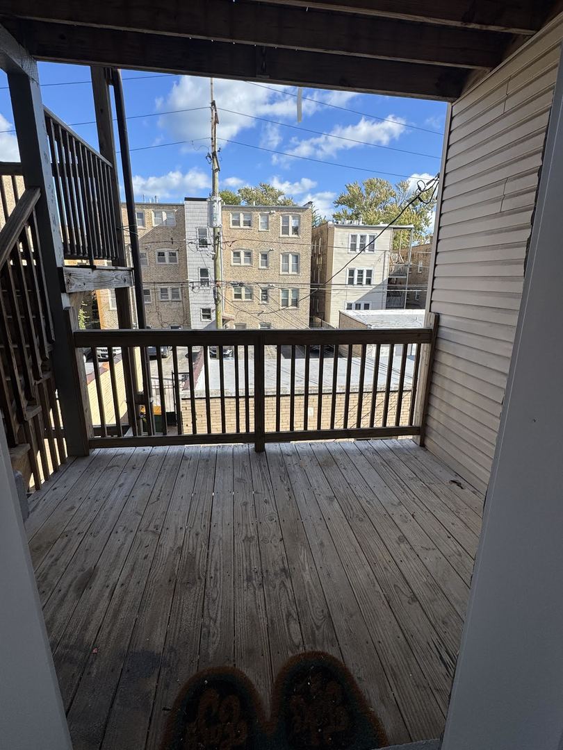 6231 North Francisco Avenue, Unit 2S Chicago, IL 60659 - Photo 24 of 24 a view of a balcony with wooden floor