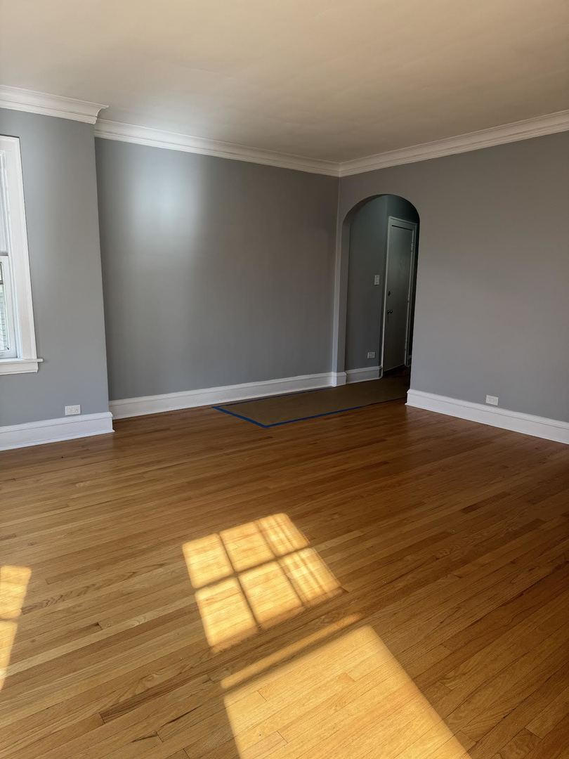 6231 North Francisco Avenue, Unit 2S Chicago, IL 60659 - Photo 3 of 24 a view of an empty room and wooden floor