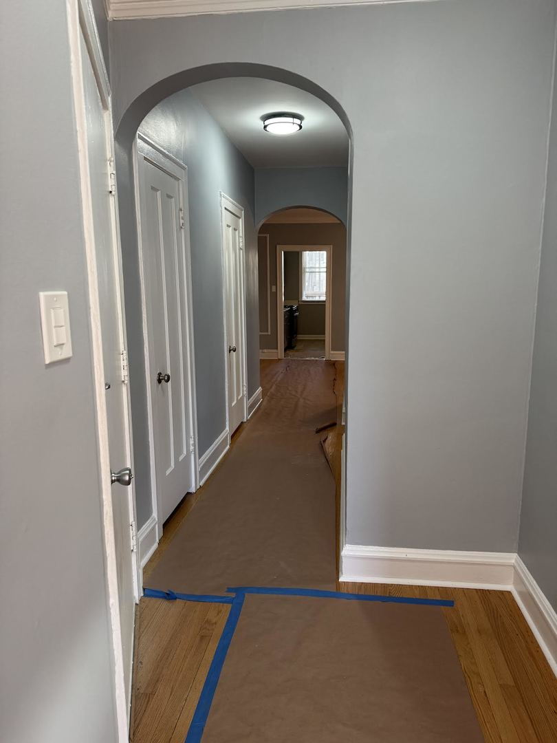 6231 North Francisco Avenue, Unit 2S Chicago, IL 60659 - Photo 5 of 24 a view of a hallway with wooden floor