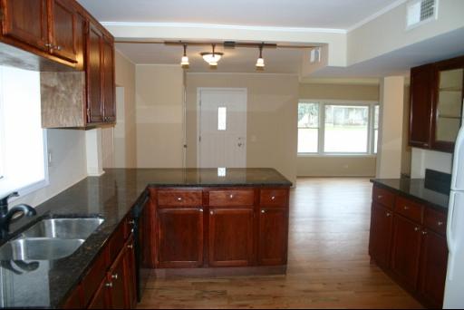 6713 Clarendon Hills Road Darien, IL 60561 - Photo 2 of 11 a kitchen with a sink and a stove top oven with wooden floor