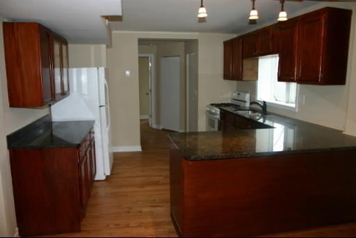 6713 Clarendon Hills Road Darien, IL 60561 - Photo 3 of 11 a kitchen with stainless steel appliances granite countertop a sink a stove and a refrigerator