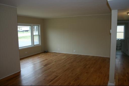6713 Clarendon Hills Road Darien, IL 60561 - Photo 5 of 11 an empty room with wooden floor and windows
