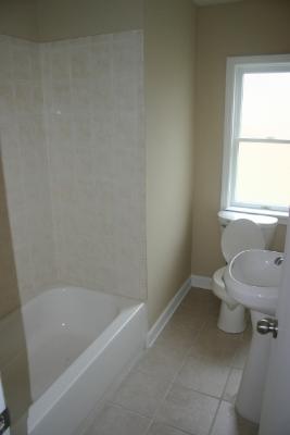 6713 Clarendon Hills Road Darien, IL 60561 - Photo 6 of 11 a white bath tub sitting next to a toilet