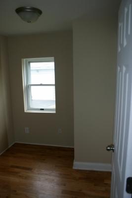 6713 Clarendon Hills Road Darien, IL 60561 - Photo 7 of 11 a view of an empty room with wooden floor and a window