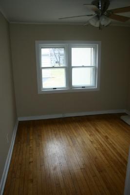 6713 Clarendon Hills Road Darien, IL 60561 - Photo 8 of 11 an empty room with wooden floor and windows
