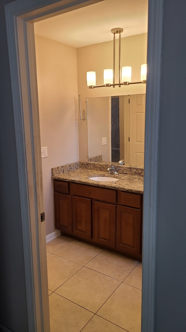 125 Deerpath Road Matteson, IL 60443 - Photo 16 of 19 a bathroom with a granite countertop sink and a mirror