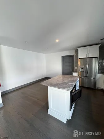 a kitchen with a stove and a refrigerator