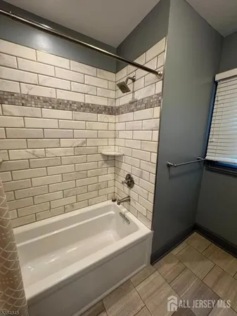 a bathroom with a bathtub and shower