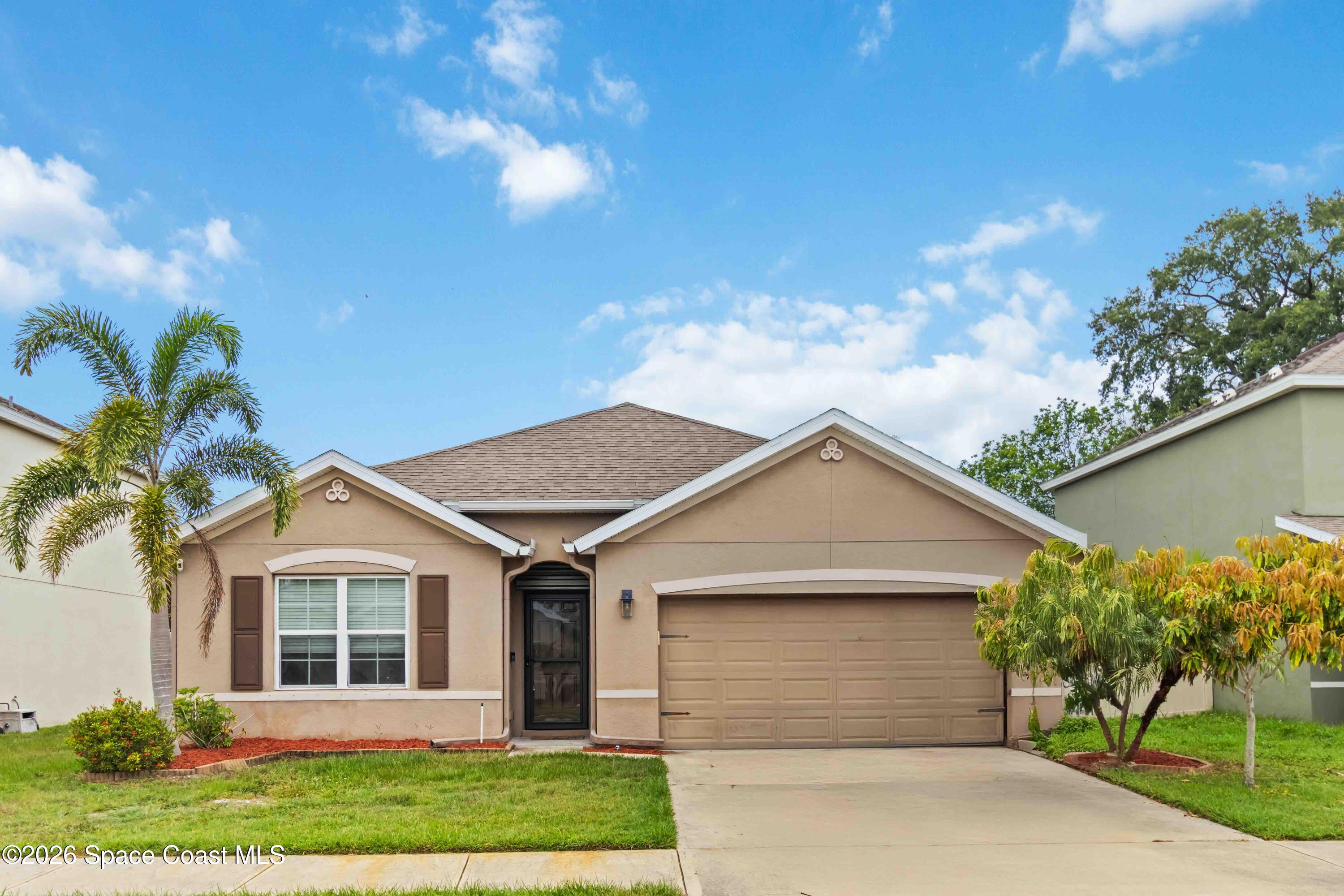 1070 Swiss Pointe Lane Rockledge, FL 32955 - Photo 1 of 18 a view of a white house next to a yard and a yard