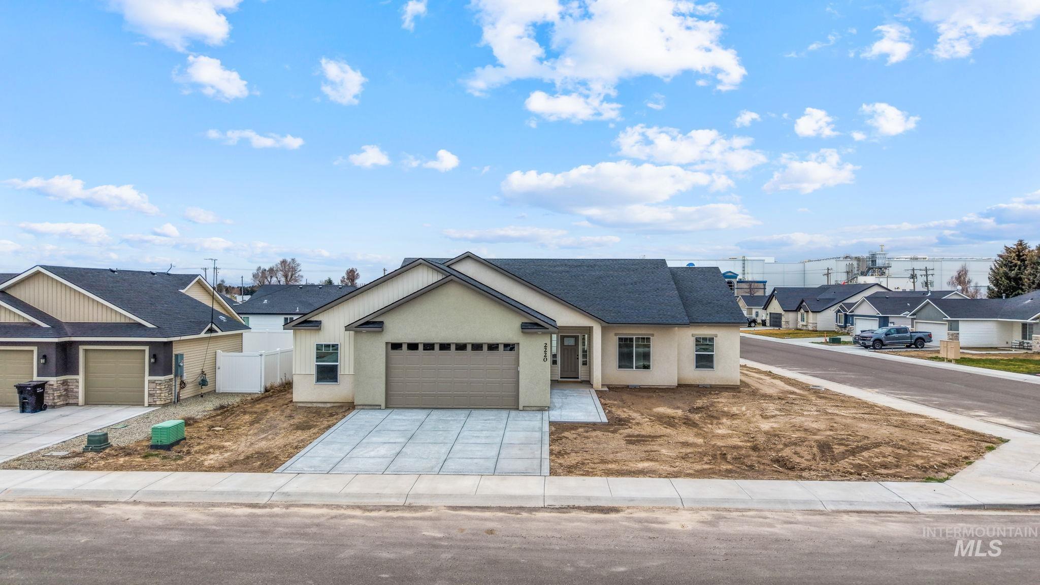 2220 Great Basin Way Burley, ID 83318 - Photo 2 of 39 View of front facade with a residential view, a garage, concrete driveway, roof with shingles, and stucco siding