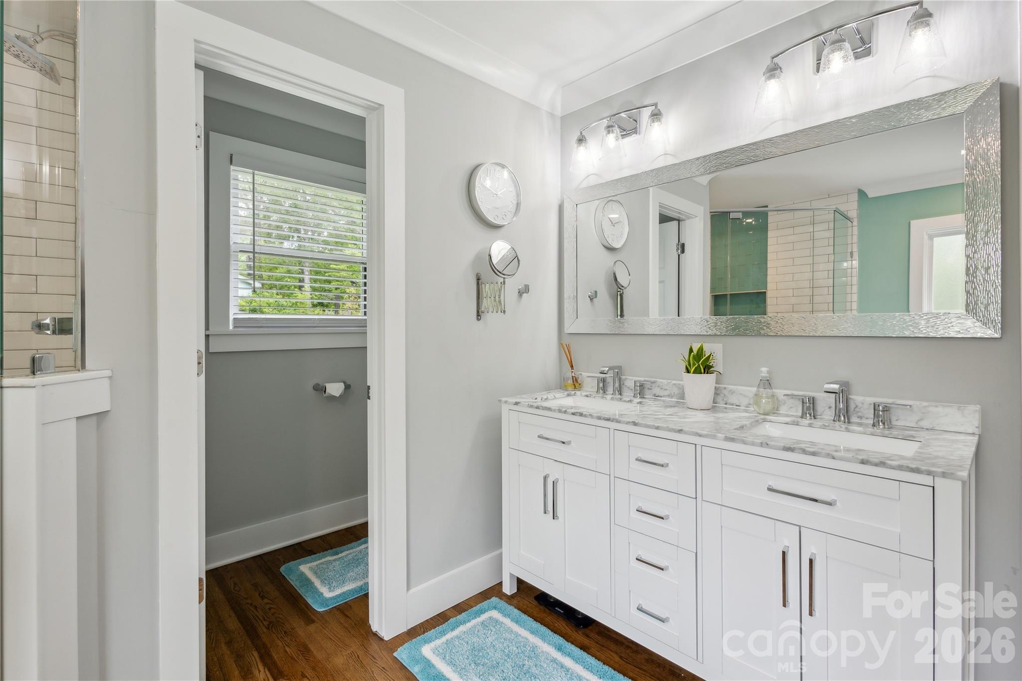 7200 Monroe Road Charlotte, NC 28212 - Photo 19 of 37 a spacious bathroom with a granite countertop sink a mirror and a
