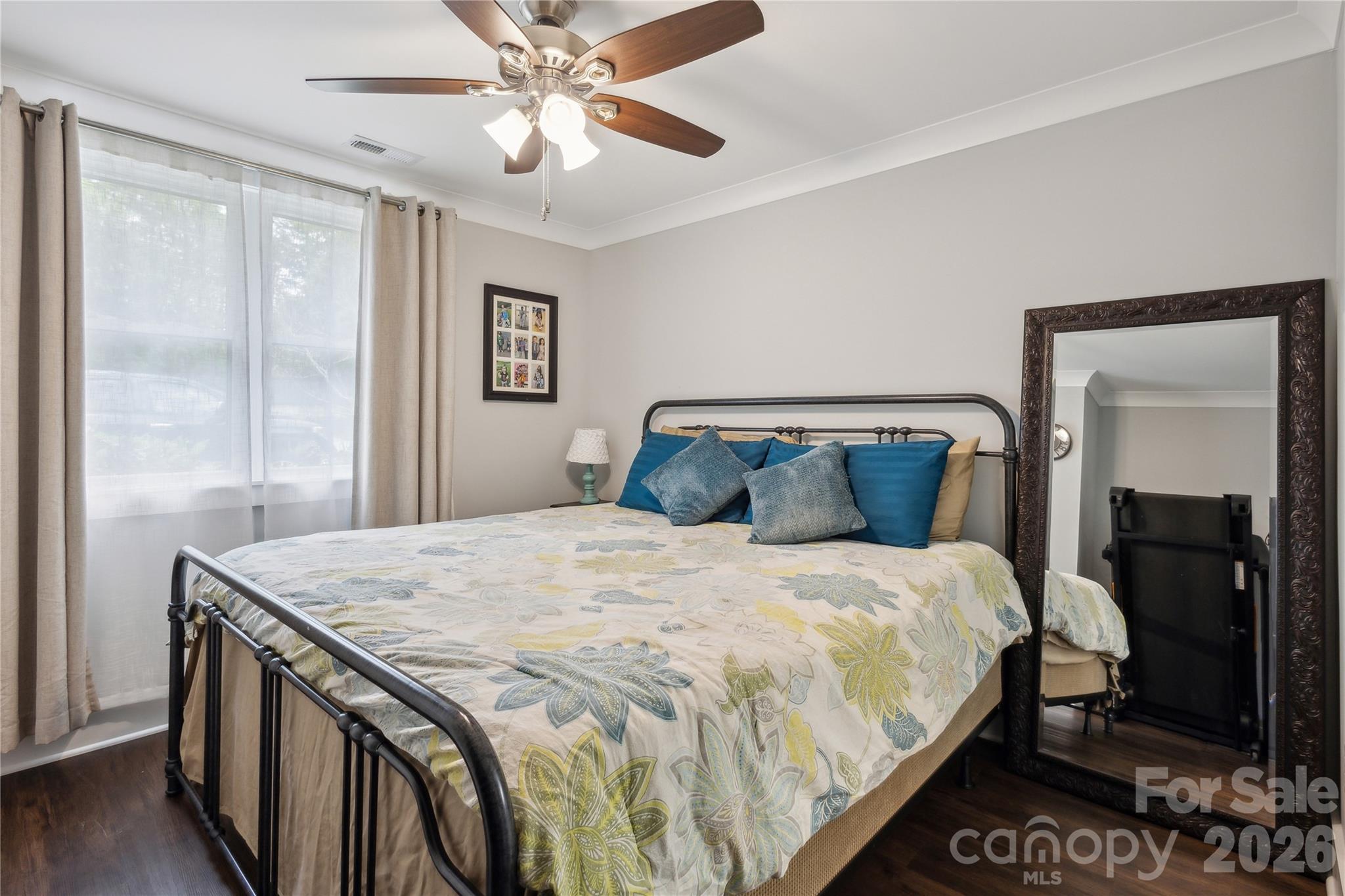 7200 Monroe Road Charlotte, NC 28212 - Photo 25 of 37 a bedroom with a bed and a chandelier