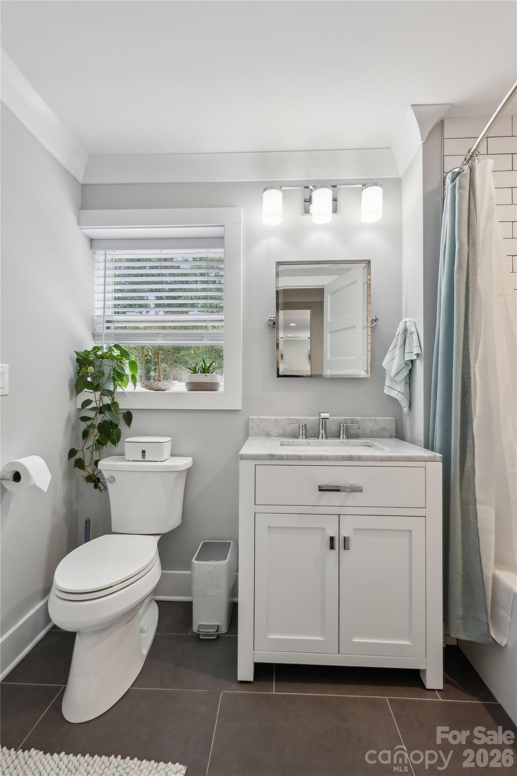 7200 Monroe Road Charlotte, NC 28212 - Photo 27 of 37 a bathroom with a granite countertop toilet sink and mirror