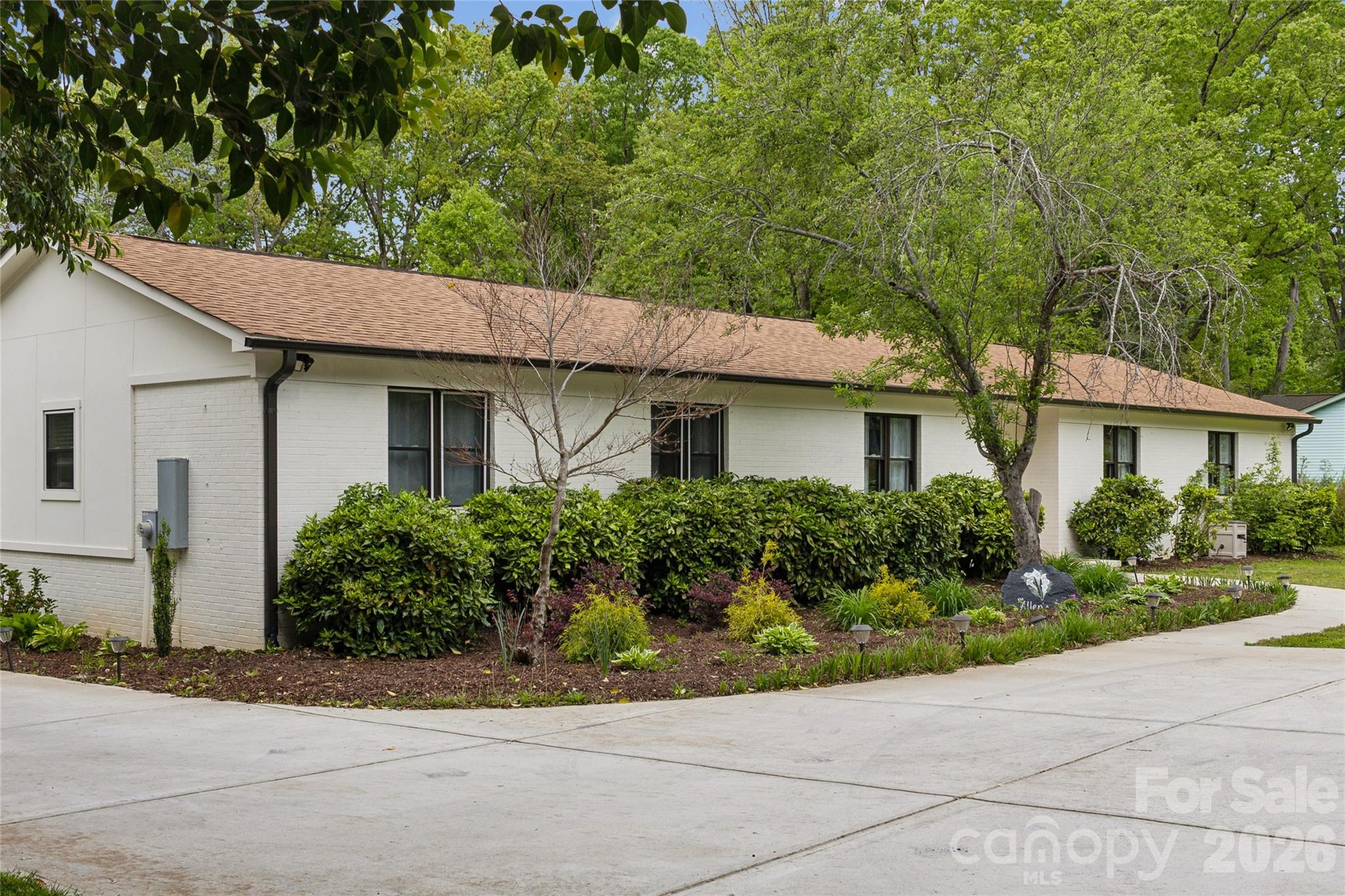 7200 Monroe Road Charlotte, NC 28212 - Photo 36 of 37 a front view of a house with a garden
