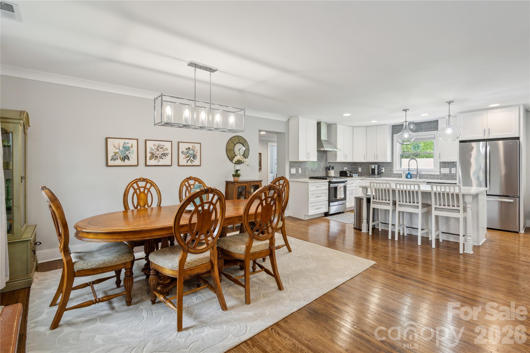 7200 Monroe Road Charlotte, NC 28212 - Photo 7 of 37 a view of a dining room with furniture and wooden floor