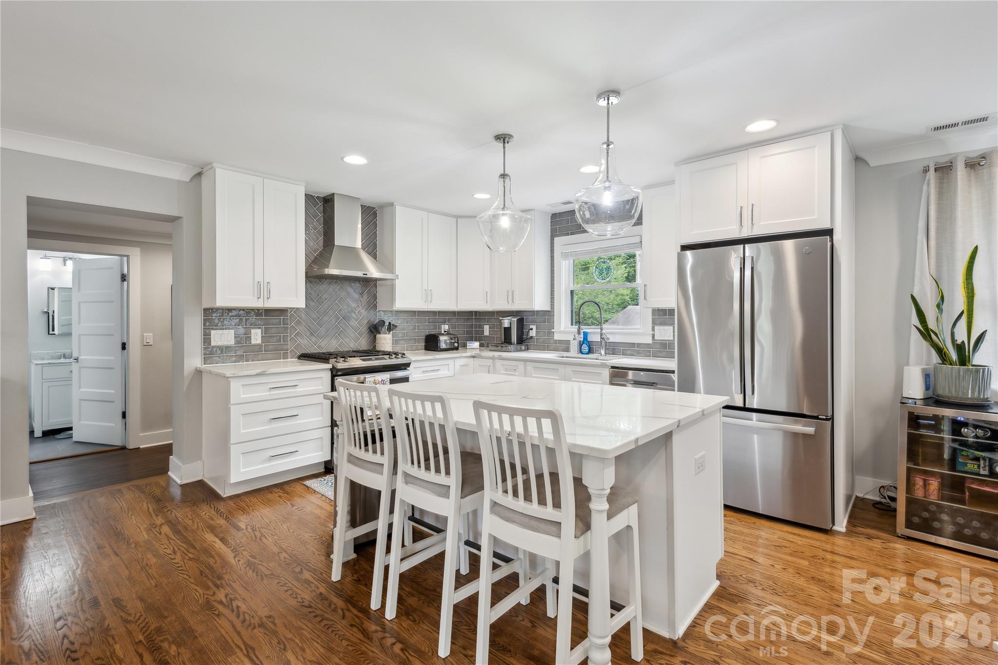 7200 Monroe Road Charlotte, NC 28212 - Photo 8 of 37 a kitchen with stainless steel appliances granite countertop a refrigerator a sink dishwasher a stove and a refrigerator with wooden floor