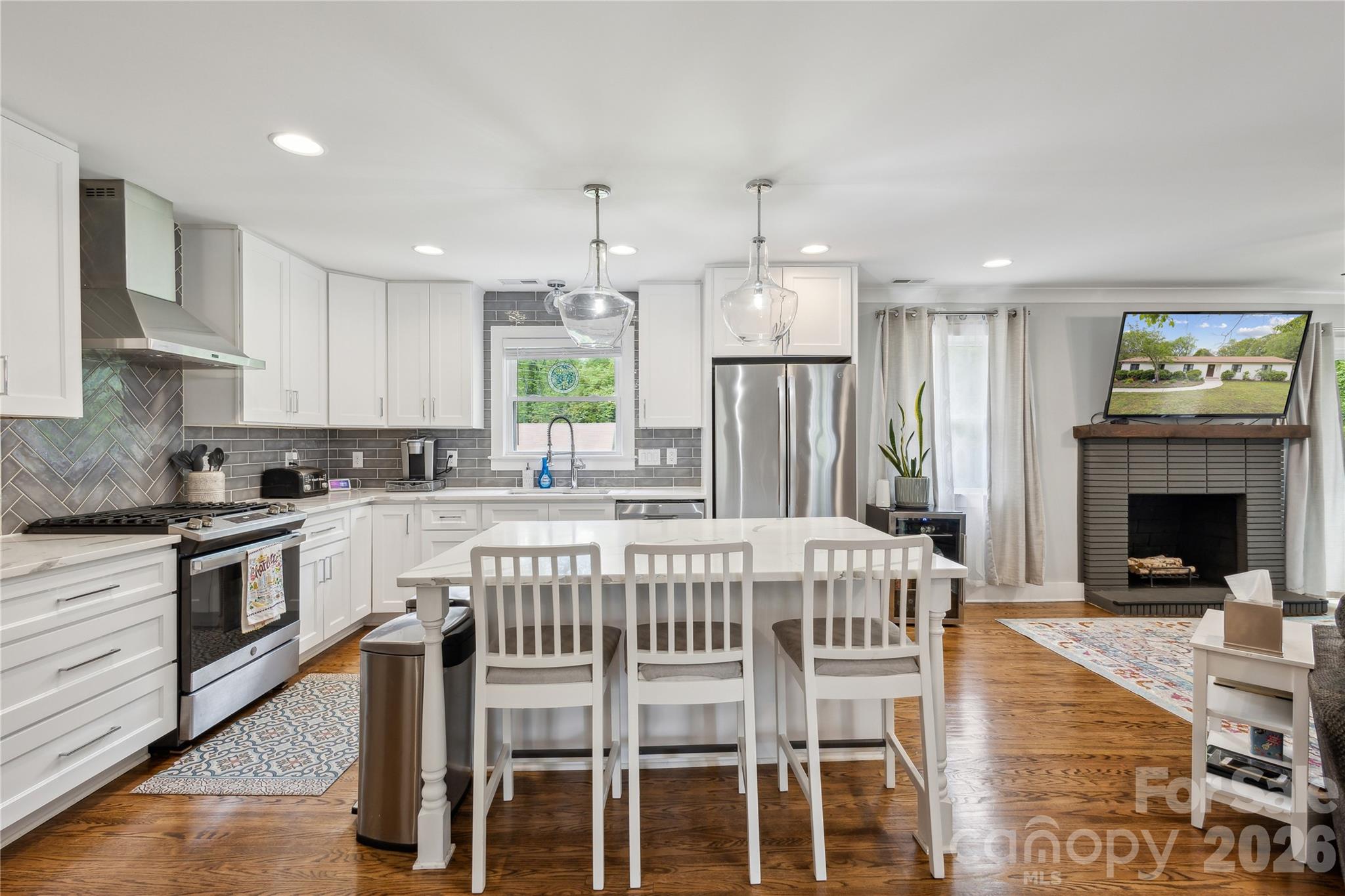 7200 Monroe Road Charlotte, NC 28212 - Photo 9 of 37 a large kitchen with a table chairs refrigerator and microwave
