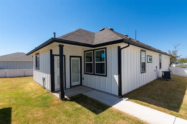 a view of a house with wooden fence