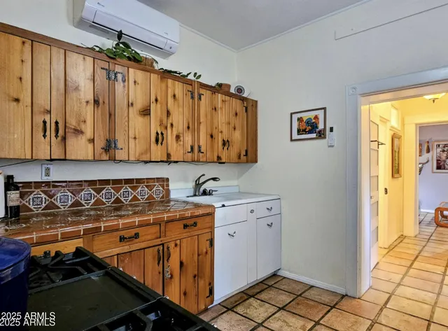 a utility room with stainless steel appliances a stove a window and a shower
