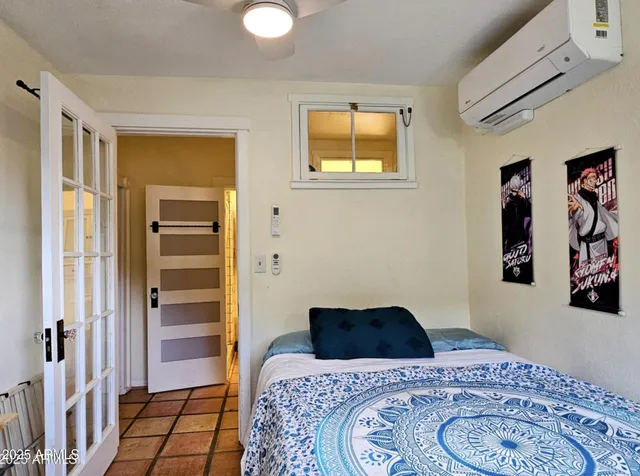 a bedroom with a bed and a window