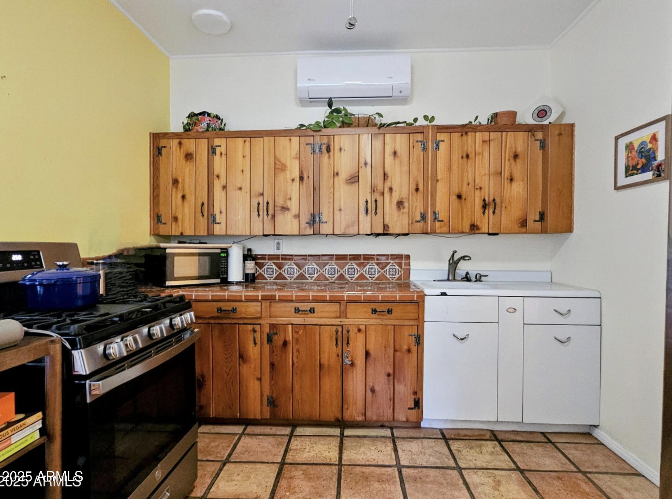 25 Cole Avenue Bisbee, AZ 85603 - Photo 9 of 15 a kitchen with stainless steel appliances a stove a sink and cabinets