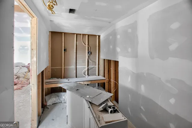 a bedroom with furniture and large window