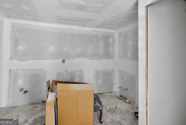 a view of a hallway with bathroom and shower