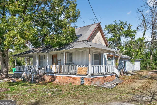 a view of a house with a yard and deck