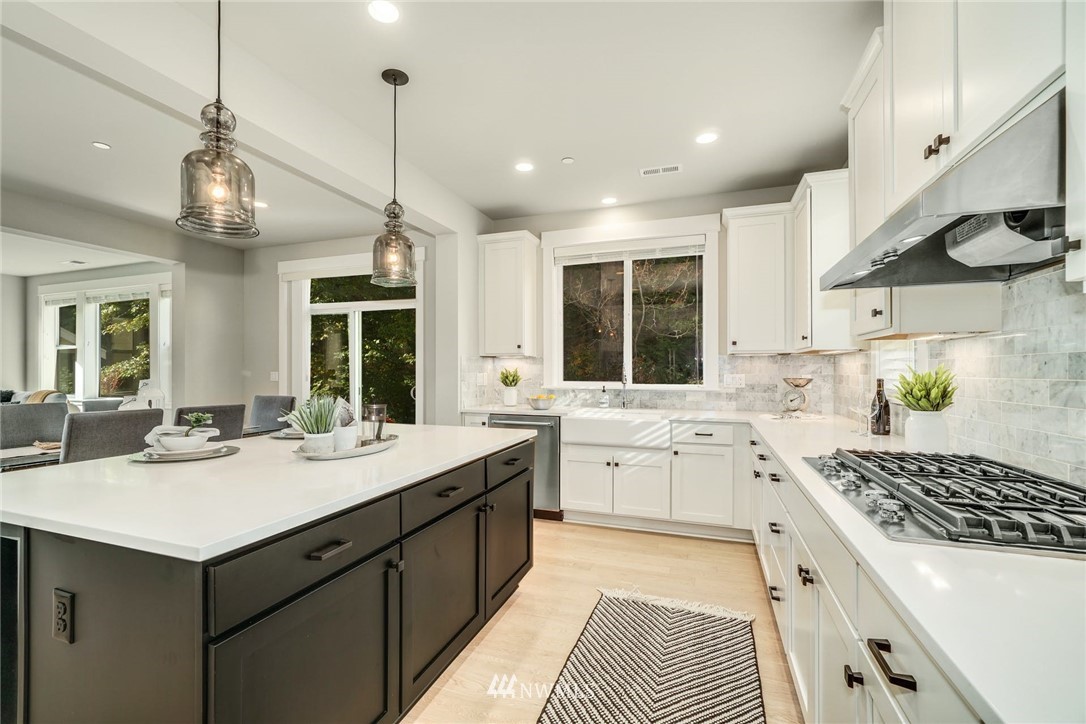 3318 238th Place Southeast Bothell, WA 98021 - Photo 13 of 36 a kitchen with a sink stove and cabinets