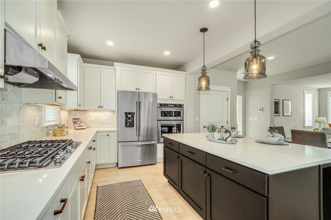 3318 238th Place Southeast Bothell, WA 98021 - Photo 14 of 36 a kitchen with a sink stove and refrigerator