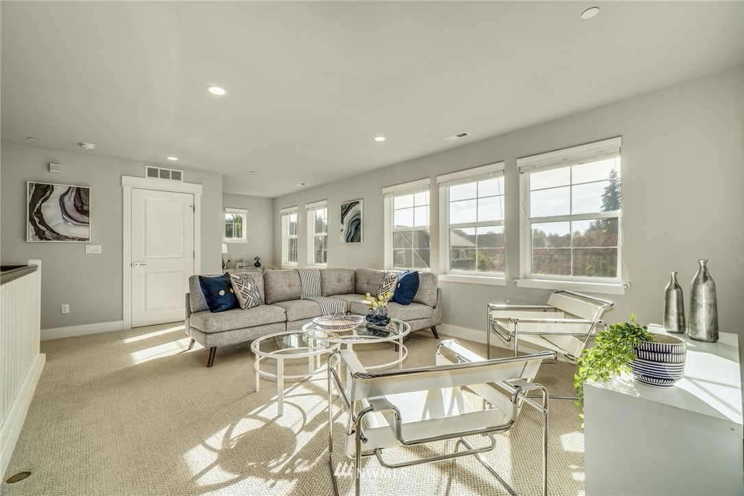 3318 238th Place Southeast Bothell, WA 98021 - Photo 15 of 36 a living room with furniture and a large window