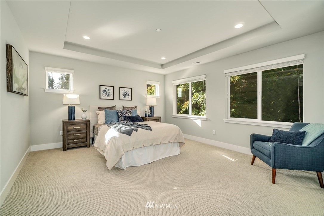 3318 238th Place Southeast Bothell, WA 98021 - Photo 21 of 36 a spacious bedroom with a bed and glass window