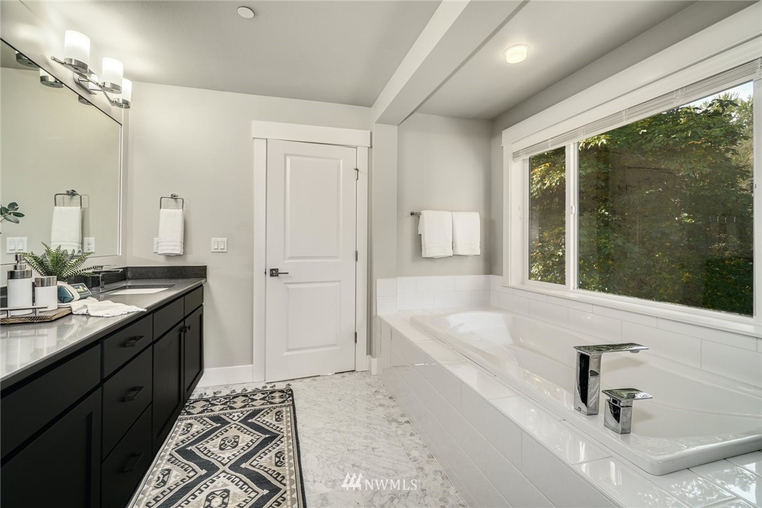 3318 238th Place Southeast Bothell, WA 98021 - Photo 25 of 36 a spacious bathroom with a tub sink and mirror