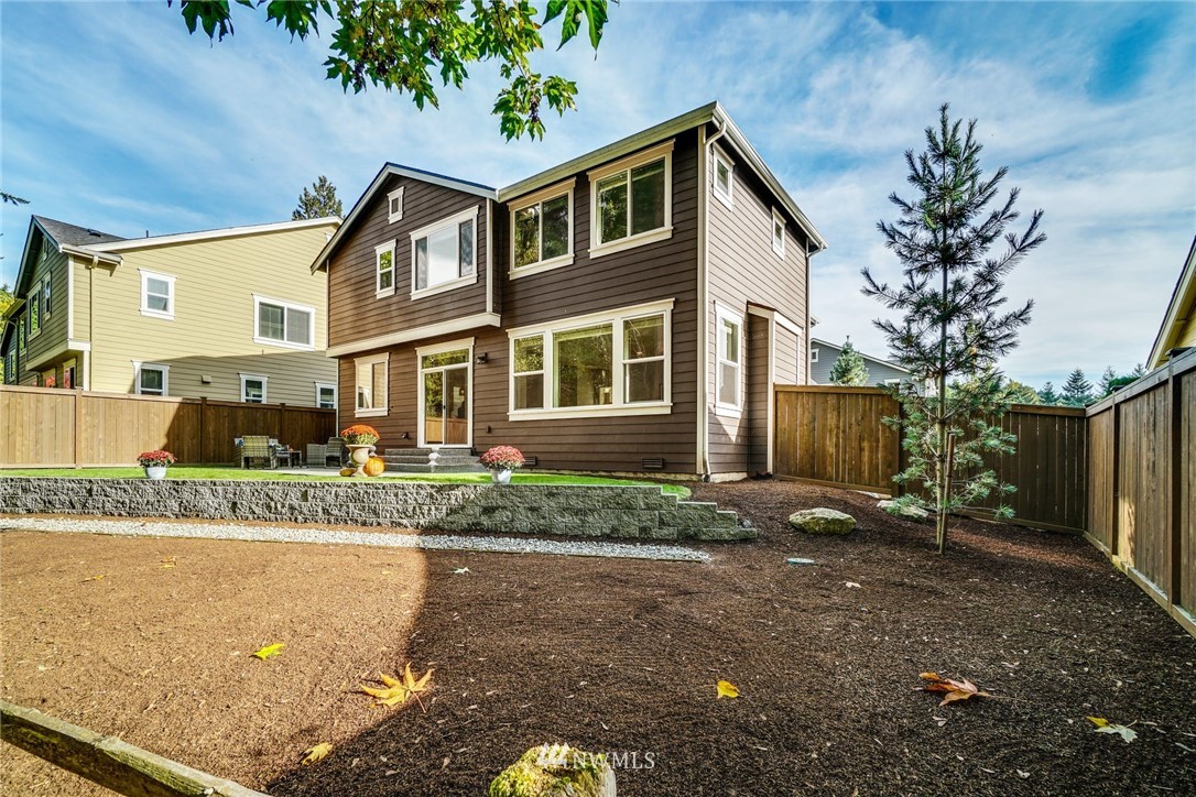 3318 238th Place Southeast Bothell, WA 98021 - Photo 28 of 36 a front view of a house with a garden and yard
