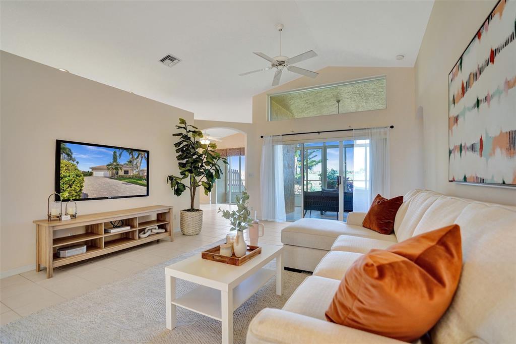 7219 Modena Drive Boynton Beach, FL 33437 - Photo 13 of 47 a living room with furniture ceiling fan and a rug