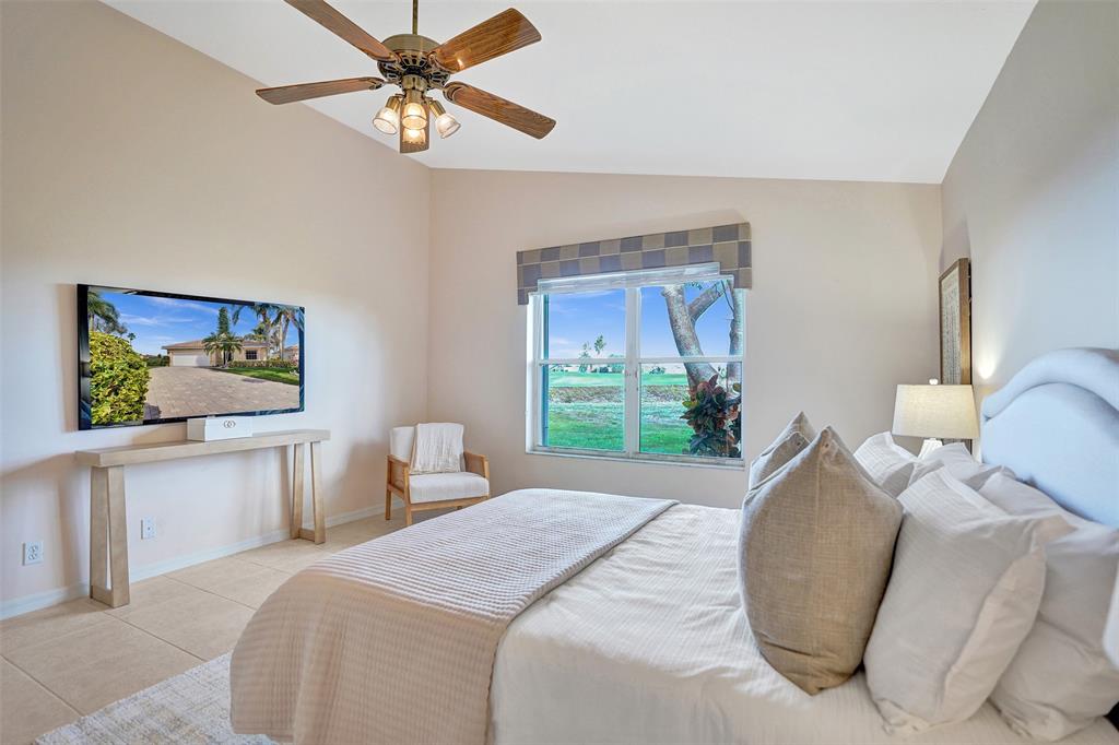 7219 Modena Drive Boynton Beach, FL 33437 - Photo 22 of 47 a bedroom with a bed and a chandelier